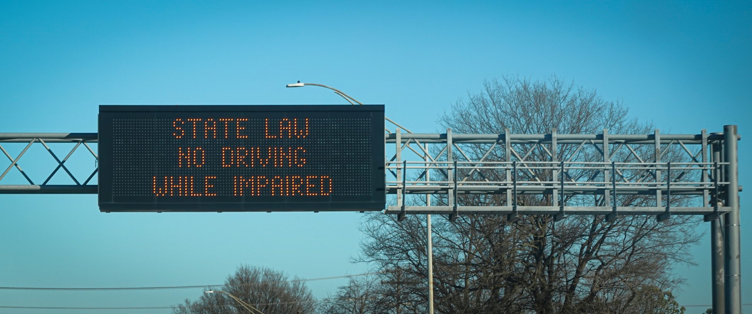 overhead highway sign reminding drivers to drive sober