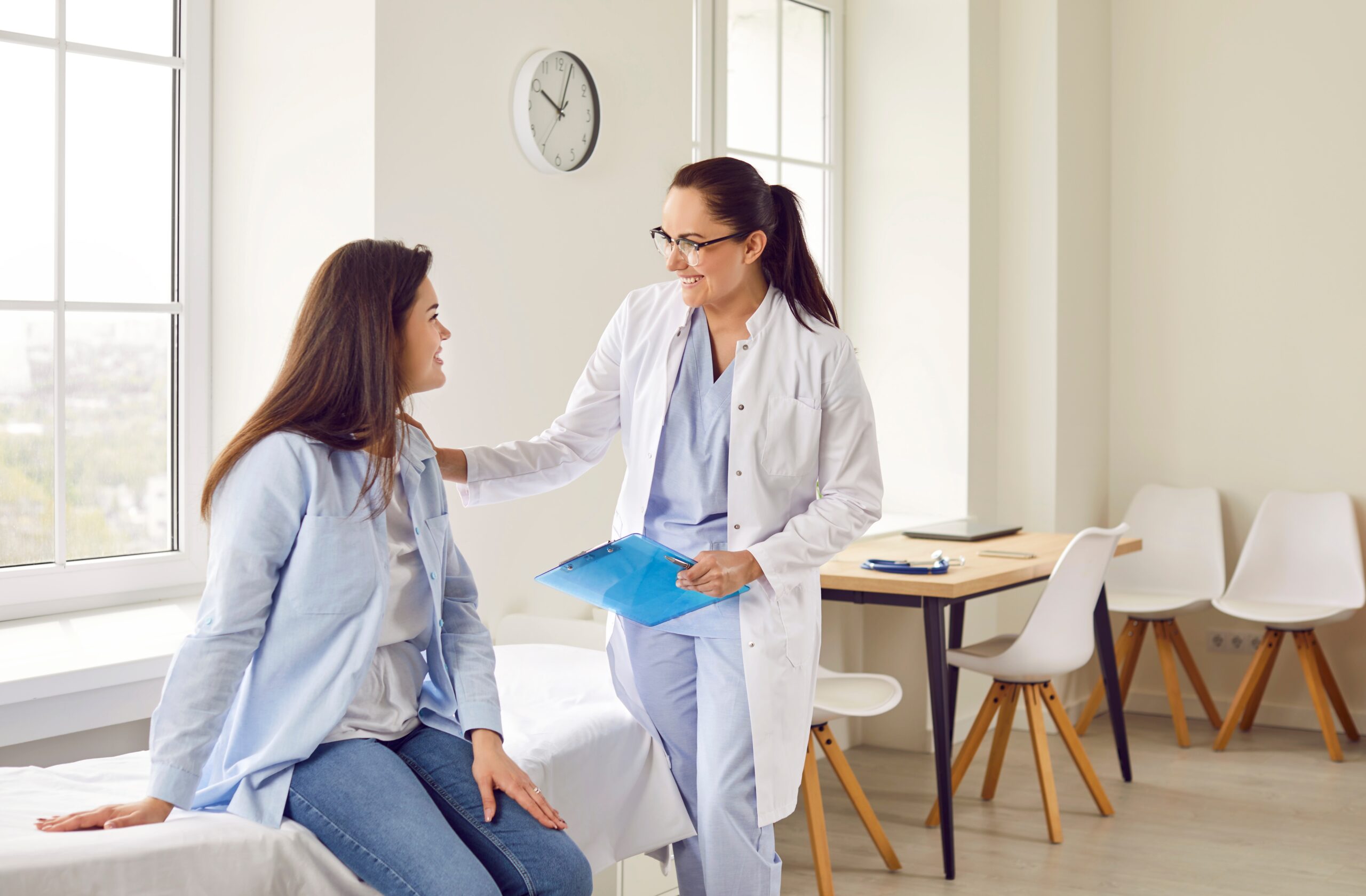 female sitting and speaking with female doctor