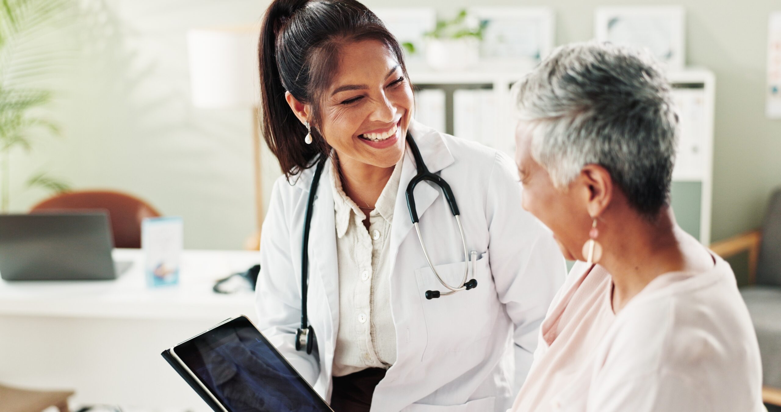 older woman with female doctor taking a look at xray