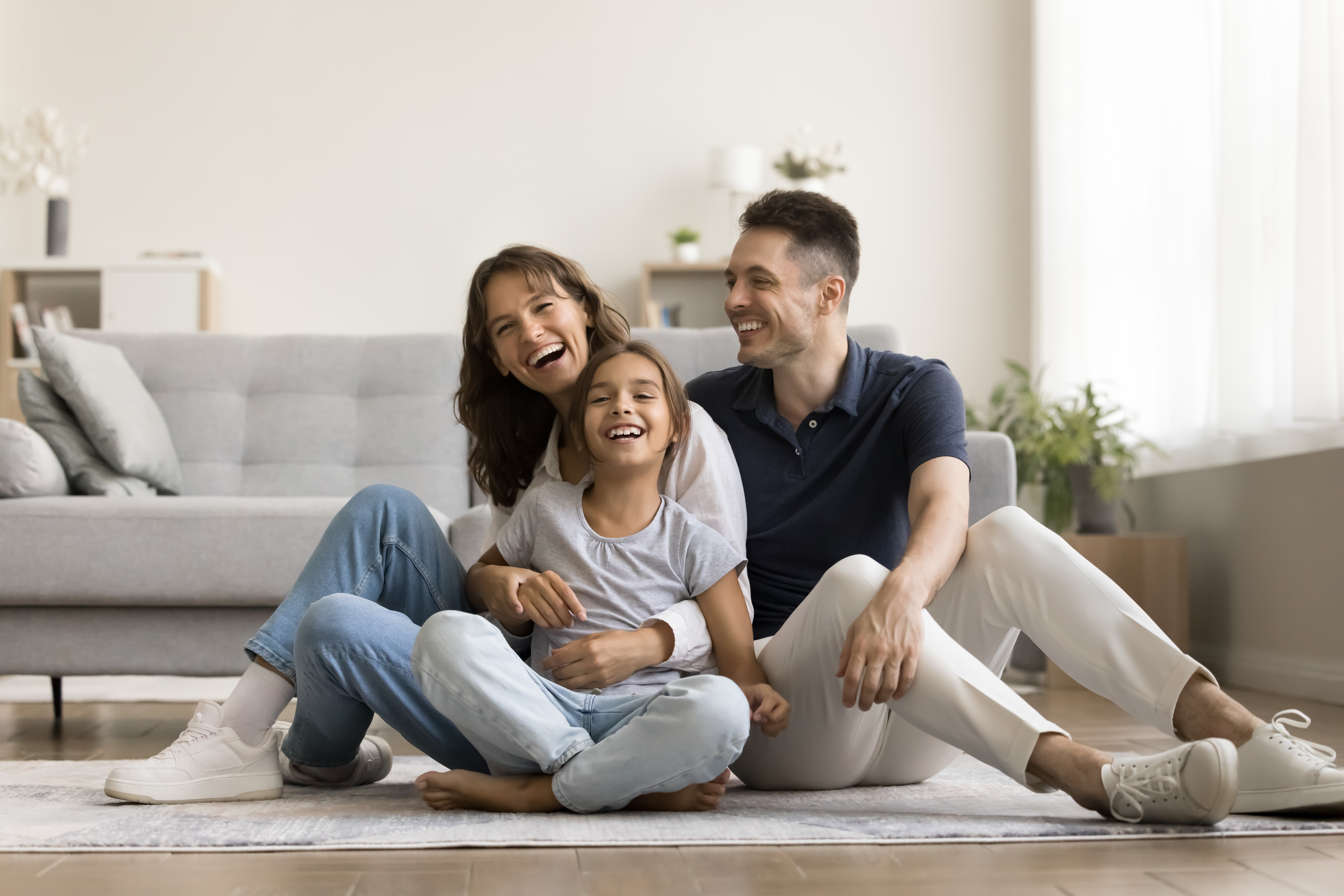 happy hispanic family laughing in their living room