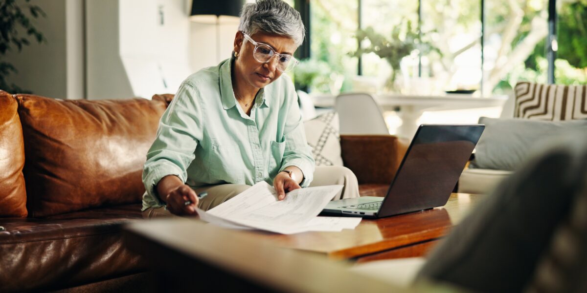 mature woman on laptop reviewing documents