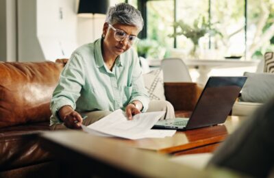 mature woman on laptop reviewing documents