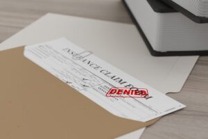 document with denied stamp on a wooden table