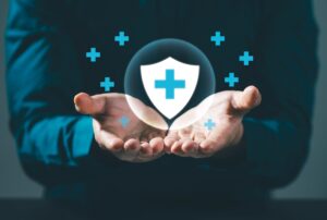 health insurance with medical symbol held in hands