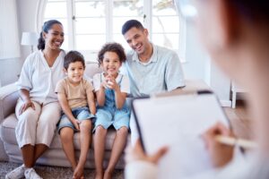 shot of a family facing woman with a clipbboard