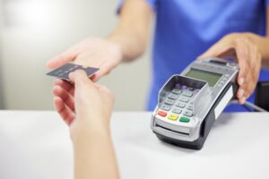 medical people and credit card with nurse taking payement