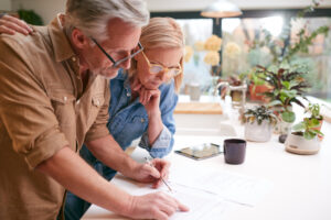 mature couple reviewing and signing paperwork
