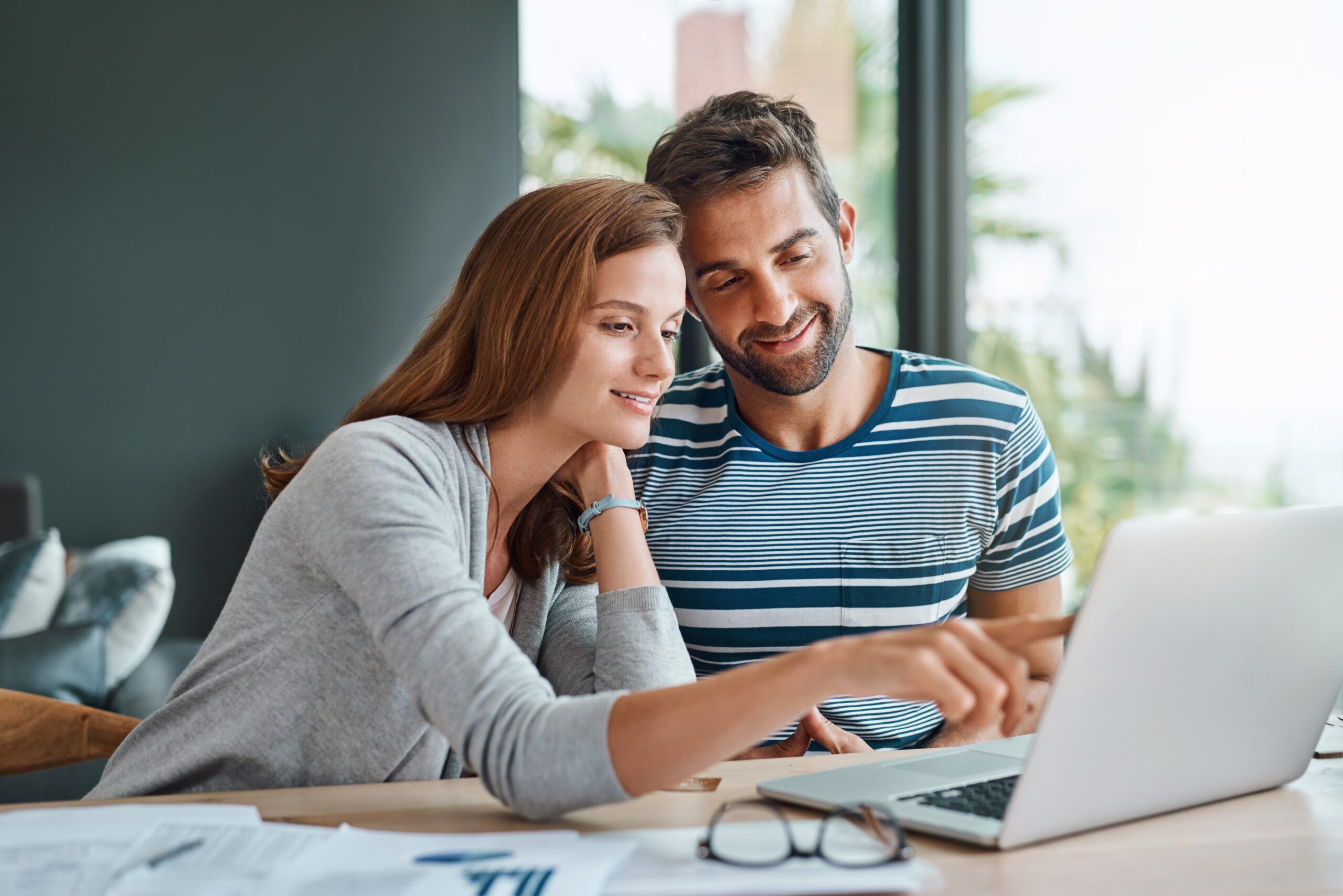 young couple looking at a laptop and planning
