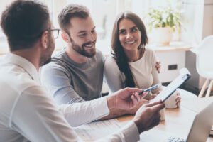 couple working with agent and asked to sign papers