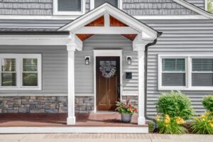 a gray modern house with a front porch