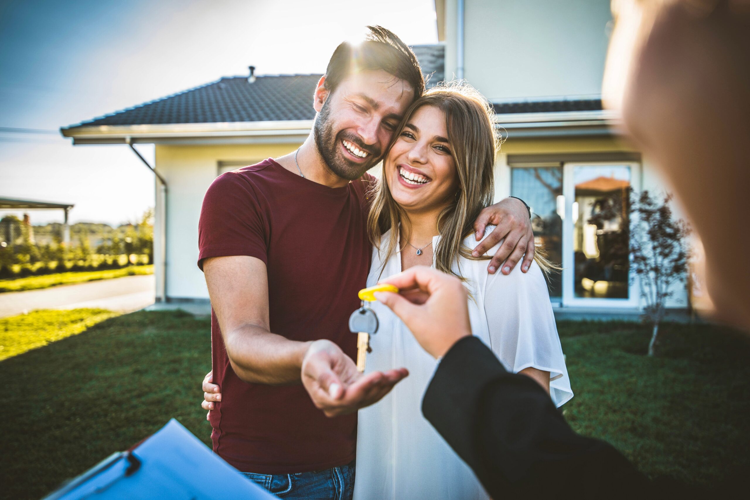 happy millennial couple receiving keys for new home