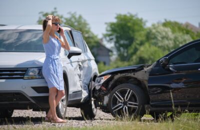 stressed woman driver on phone with accident